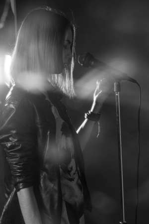 girl singing into a microphone in a studio