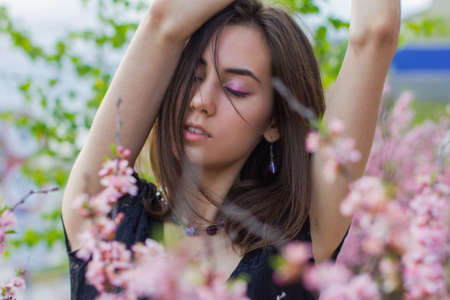 portrait of young beautiful girl in flowersの写真素材