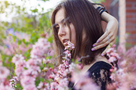 portrait of young beautiful girl in flowersの写真素材