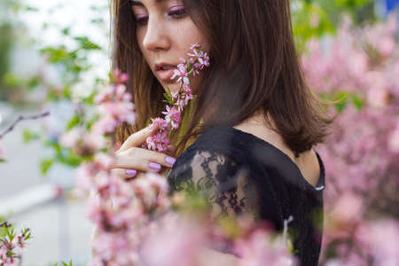 portrait of young beautiful girl in flowersの写真素材