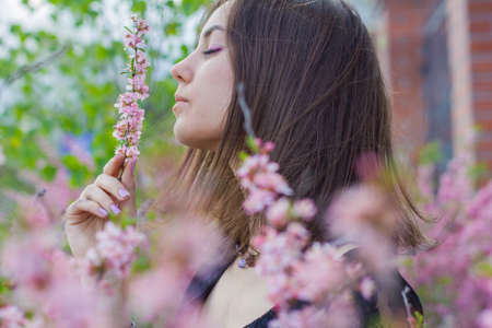 portrait of young beautiful girl in flowersの写真素材