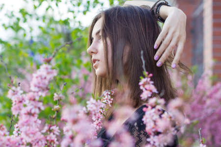 portrait of young beautiful girl in flowersの写真素材