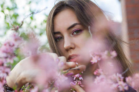 portrait of young beautiful girl in flowersの写真素材