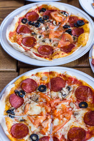 freshly prepared delicious pizza in the kitchenの写真素材