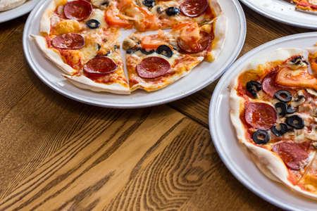 freshly prepared delicious pizza in the kitchenの写真素材