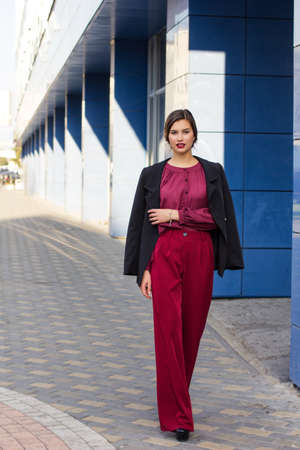 fashion stylish girl in a blouse on the streetの写真素材