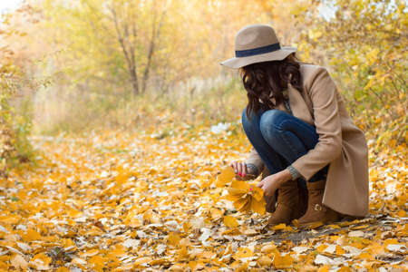 autumn walk girl in the coat in the woodsの写真素材