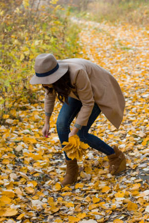 autumn walk girl in the coat in the woodsの写真素材