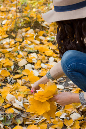 autumn walk girl in the coat in the woodsの写真素材