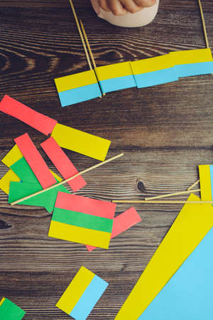 Kids are making small paper flags of Ukraine and Lithuania, Workspace in the kindergartenの写真素材