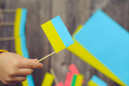 Kids are making small paper flags of Ukraine and Lithuania, Workspace in the kindergartenの写真素材