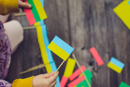 Kids are making small paper flags of Ukraine and Lithuania, Workspace in the kindergartenの写真素材