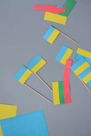Kids are making small paper flags of Ukraine and Lithuania, Workspace in the kindergartenの写真素材
