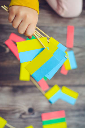 Kids are making small paper flags of Ukraine and Lithuania, Workspace in the kindergartenの写真素材