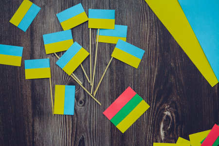 Kids are making small paper flags of Ukraine and Lithuania, Workspace in the kindergartenの写真素材