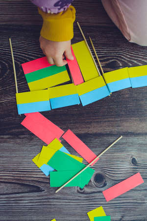 Kids are making small paper flags of Ukraine and Lithuania, Workspace in the kindergartenの写真素材