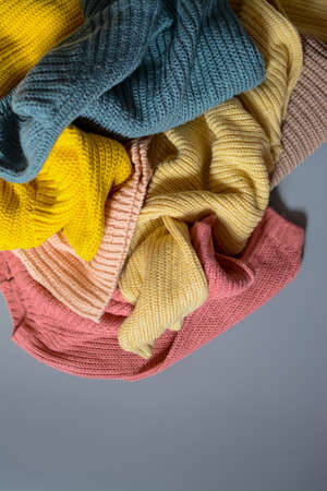 Various colors baby sweaters on dark gray backgroundの写真素材