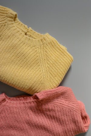 Various colors baby sweaters on dark gray backgroundの写真素材