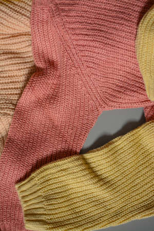 Various colors baby sweaters on dark gray backgroundの写真素材
