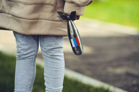 Child is playing with small missile figurine with Russia's flag on itの写真素材