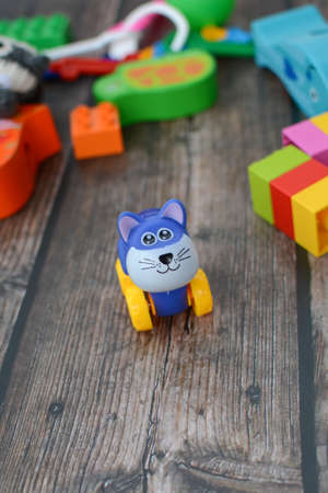 Small plastic and wooden toys in the room on the dark wooden floorの写真素材
