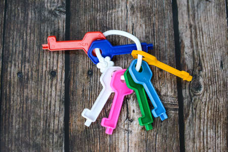 Small plastic and wooden toys in the room on the dark wooden floorの写真素材