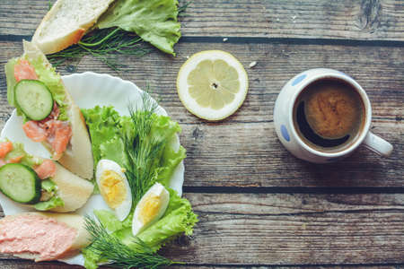 Salmon sandwich and coffee for breakfastの写真素材