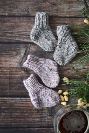 Small chunky and warm baby socks, made of woolen yarnの写真素材