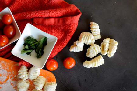 Making Italian gnocchi for breakfast, cooking process in the kitchenの写真素材