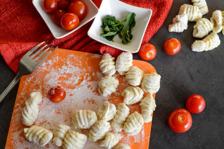 Making Italian gnocchi for breakfast, cooking process in the kitchenの写真素材