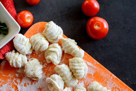 Making Italian gnocchi for breakfast, cooking process in the kitchenの写真素材