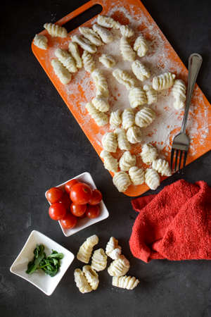 Making Italian gnocchi for breakfast, cooking process in the kitchenの写真素材