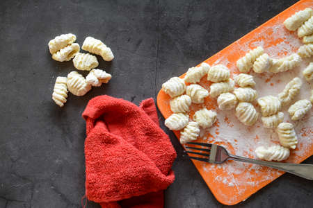 Making Italian gnocchi for breakfast, cooking process in the kitchenの写真素材