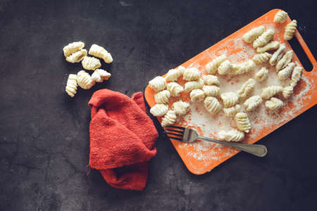 Making Italian gnocchi for breakfast, cooking process in the kitchenの写真素材