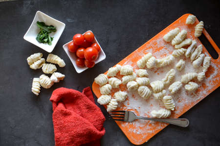 Making Italian gnocchi for breakfast, cooking process in the kitchenの写真素材