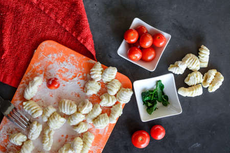Making Italian gnocchi for breakfast, cooking process in the kitchenの写真素材