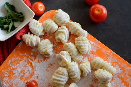Making Italian gnocchi for breakfast, cooking process in the kitchenの写真素材