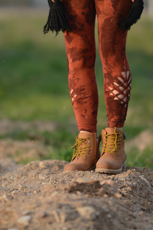 Woman legs in unique brown braided yoga leggingsの写真素材