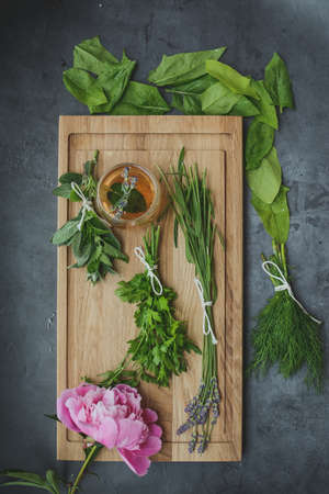 Various herbs picked from the garden, getting ready for drying, on wooden backgroundの写真素材