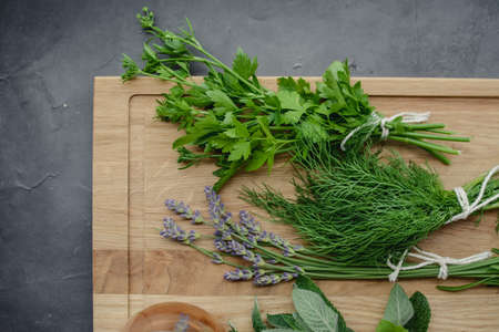 Various herbs picked from the garden, getting ready for drying, on wooden backgroundの写真素材