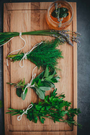 Various herbs picked from the garden, getting ready for drying, on wooden backgroundの写真素材
