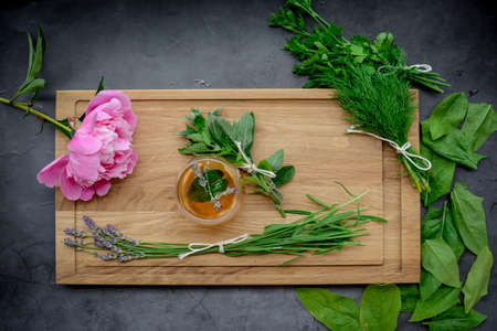 Various herbs picked from the garden, getting ready for drying, on wooden backgroundの写真素材