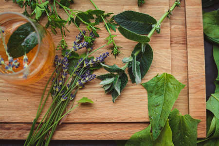 Various herbs picked from the garden, getting ready for drying, on wooden backgroundの写真素材
