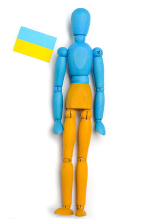 Wooden doll of Ukrainian flag colors, on gray backgroundの写真素材