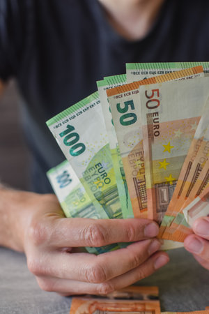 Euro banknotes in man's handsの写真素材