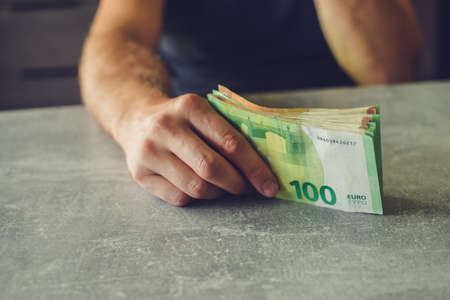 Euro banknotes in man's handsの写真素材