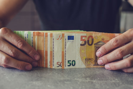 Euro banknotes in man's handsの写真素材
