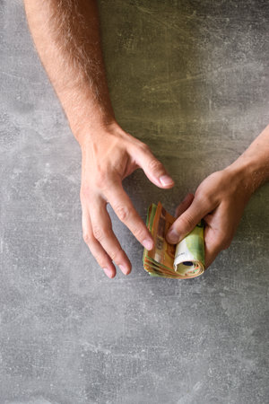 Euro banknotes in man's handsの写真素材