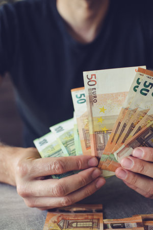 Euro banknotes in man's handsの写真素材