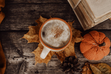 Hot spicy coffee and pile of old books on wooden backgroundの写真素材